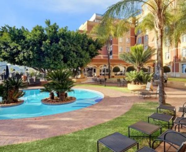 hotel resort with pool and outdoor lounge chairs